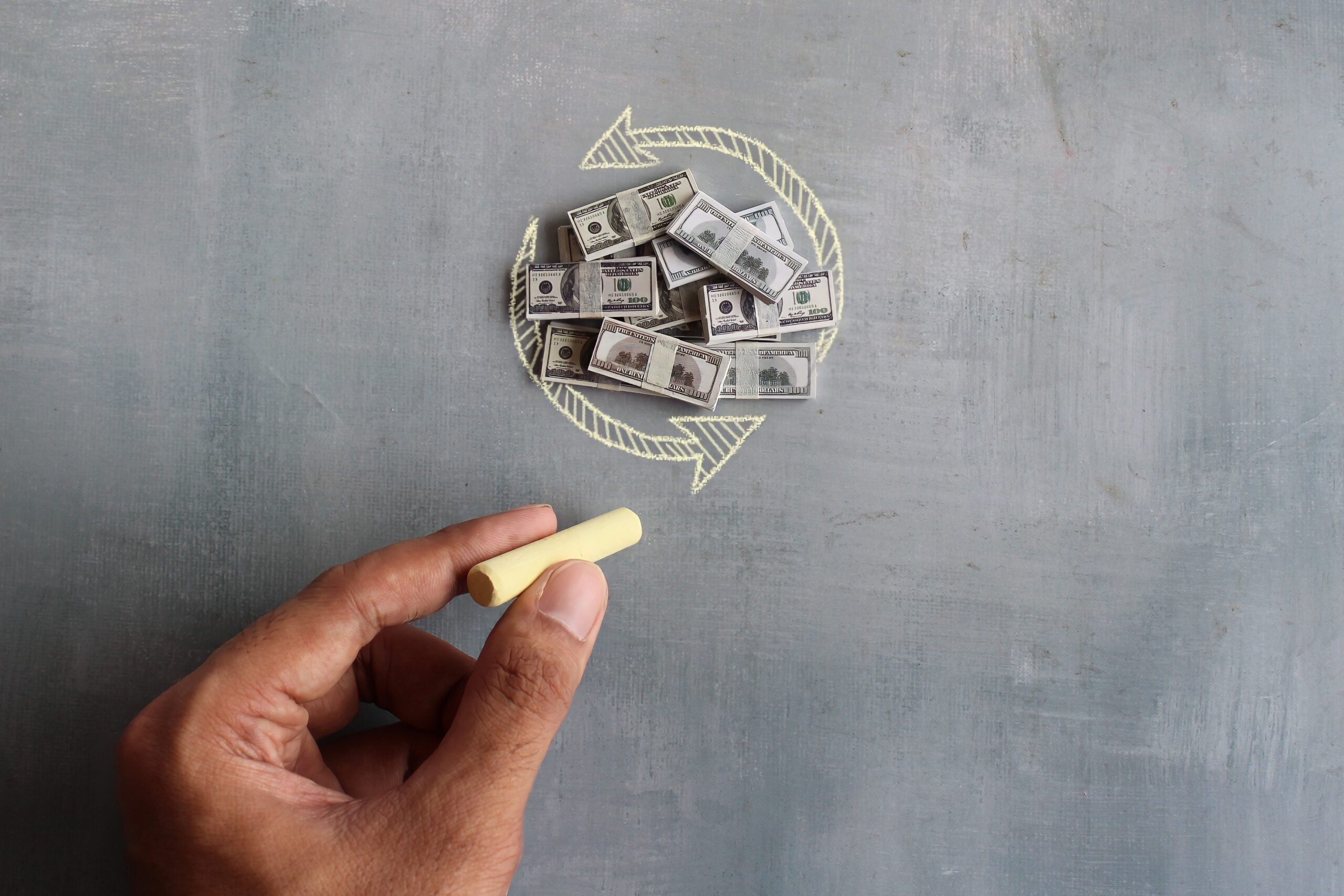 banknotes-and-hand-drawing-circular-arrow-