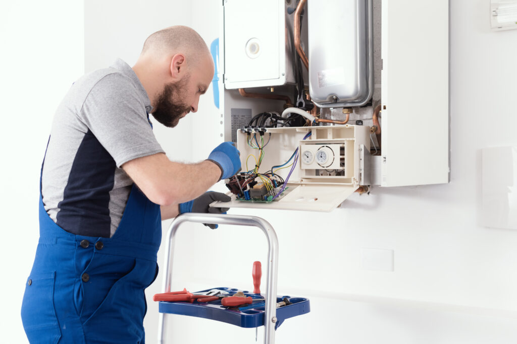 Qualified engineer servicing a boiler